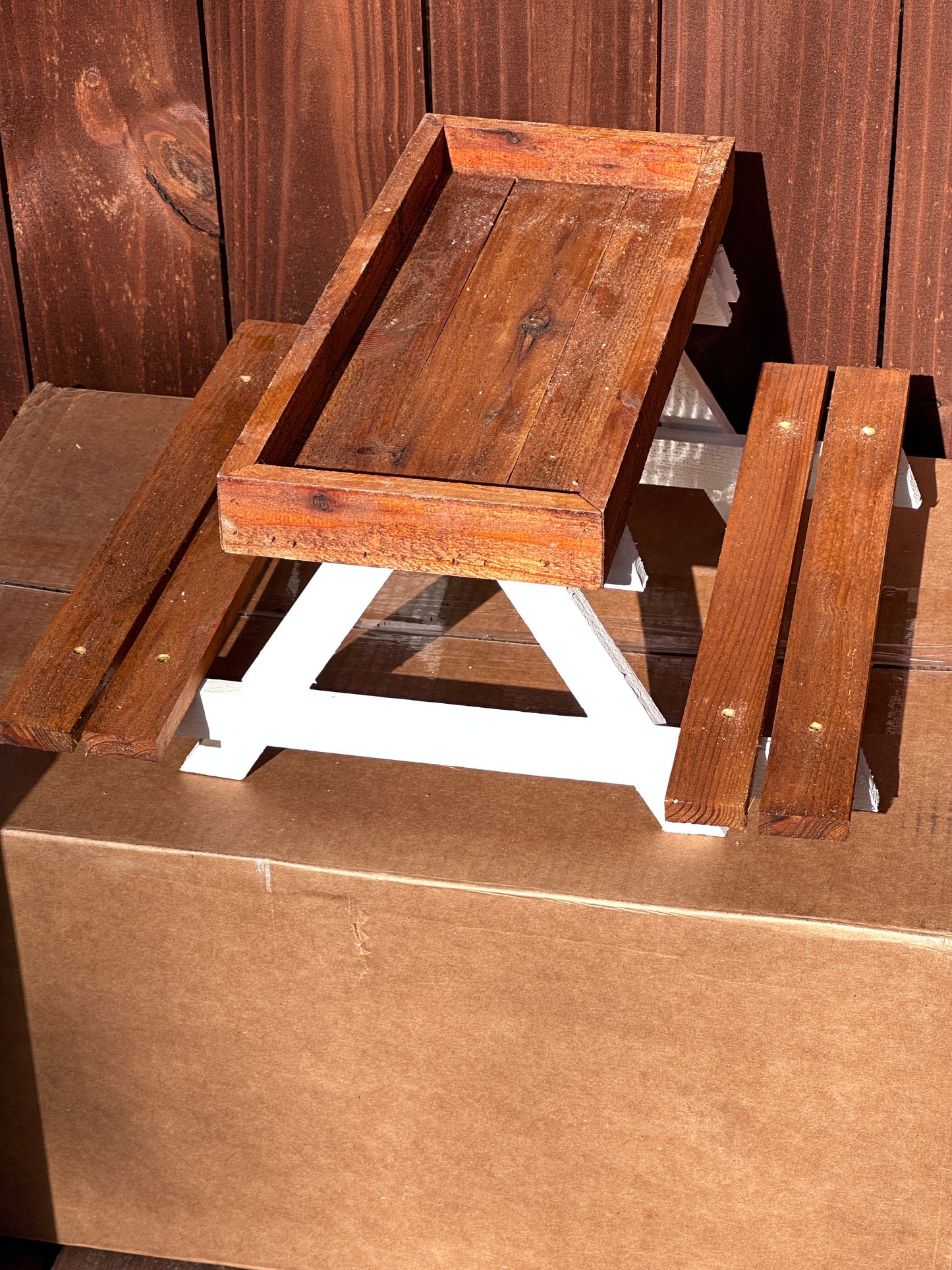 Wooden crate with glass top on a wooden surface
