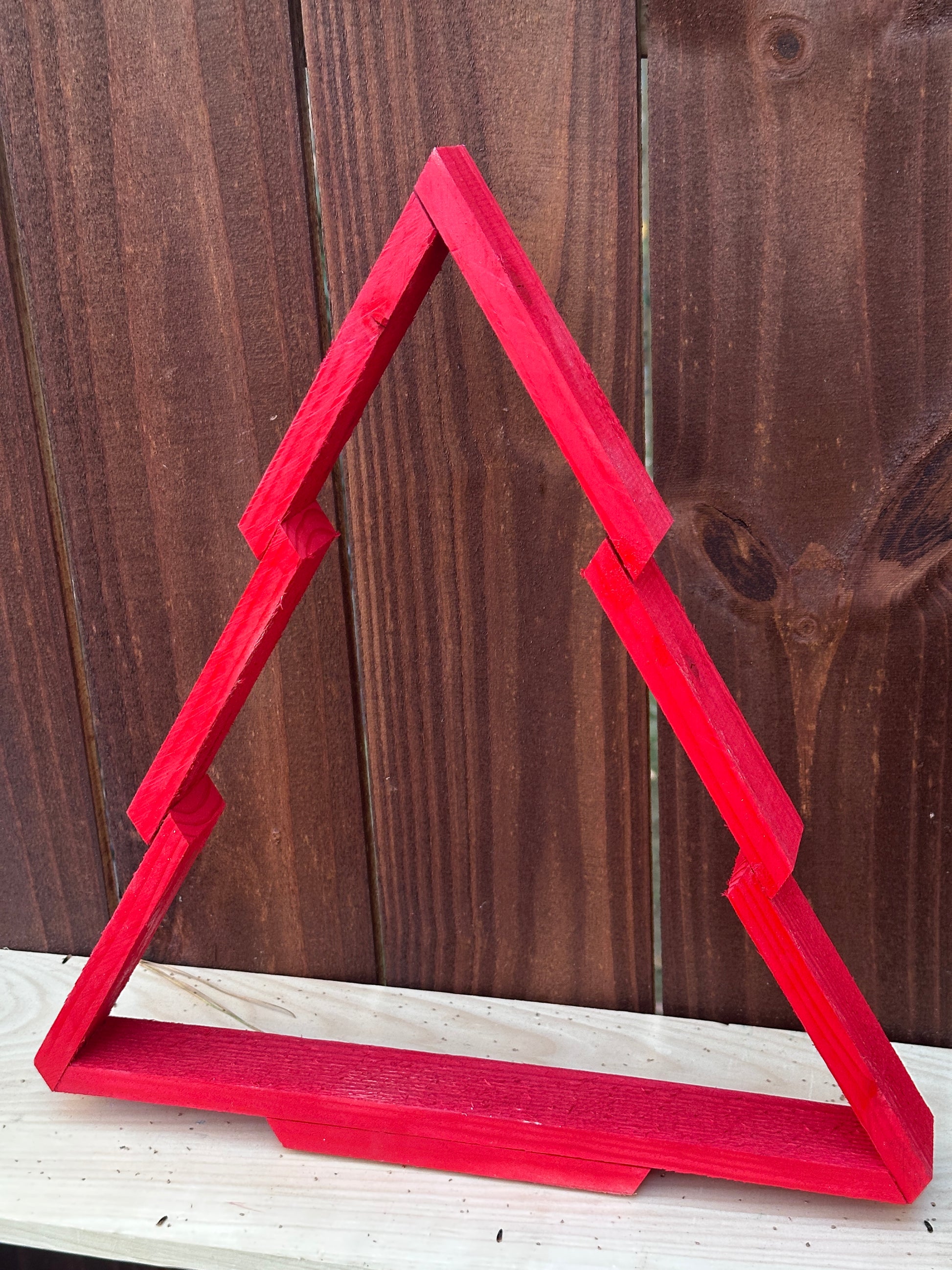 Red Wooden Christmas Tree  on a wooden surface